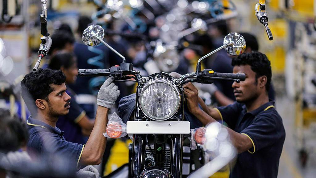 Employees assemble Royal Enfield Motors Ltd. Classic 350 motorcycles moving on a conveyor on the production line at the company's manufacturing facility in Chennai, India, on Tuesday, July 14, 2015. I