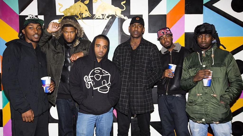 JME, Skepta and other members of Boy Better Know stood posing with hoodies and coats on
