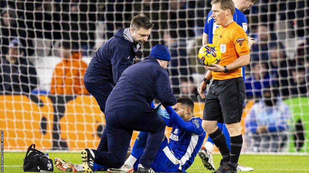 Karlan Grant is treated on the pitch