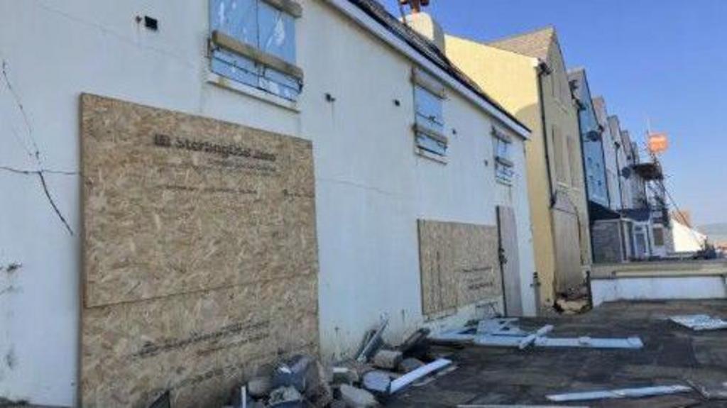 Buildings in Torcross damaged by the sea during storms.