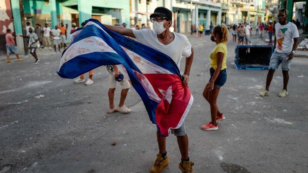 A man waves a Cuban flag during a demonstration against the government of Cuban President Miguel Diaz-Canel in Havana, on July 11, 2021.