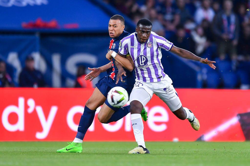 Kevin Keben tussles with Kylian Mbappe during Toulouse's Ligue 1 game with Paris St-Germain in May