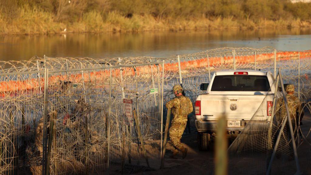 US troops amongst a maze of barbed wire on the border in Texas