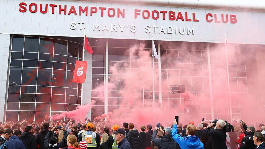 A general view of football fans holding smoke flares outside the stadium prior to the Sky Bet Championship match between Southampton and Portsmouth at St Mary's Stadium
