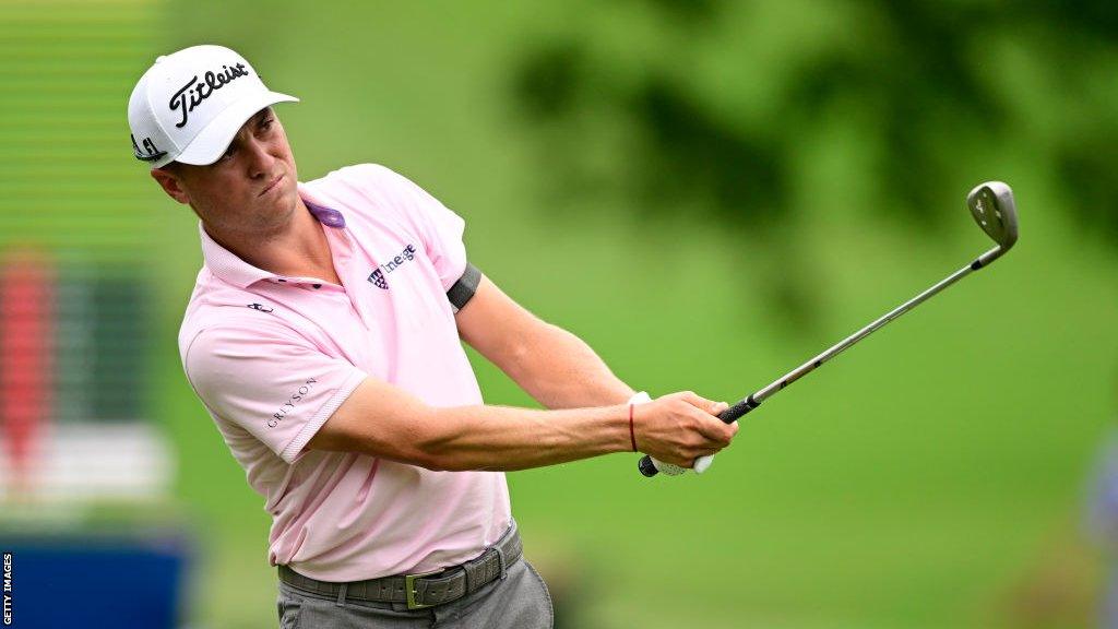 Justin Thomas swings a golf club