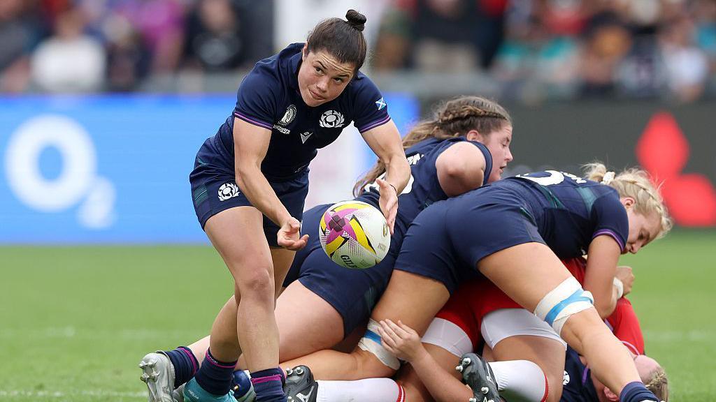 Scotland's Caity Mattinson passes the ball out of a ruck formed by her team-mates in the 2025 Rugby World Cup in Salford