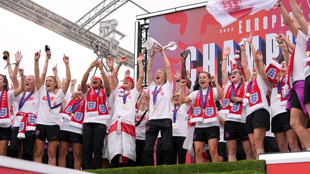 Leah Williamson of England lifts the UEFA Women's Euro trophy on stage during the England Women's team victory parade and celebration on 29 July 2025 in London, England.