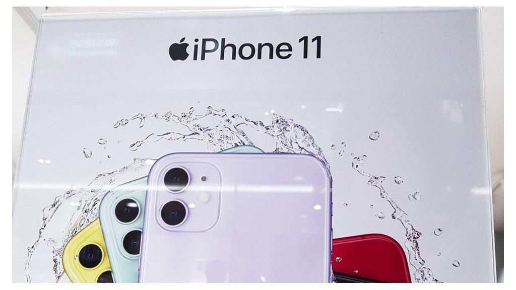 A sign promoting the iPhone 11