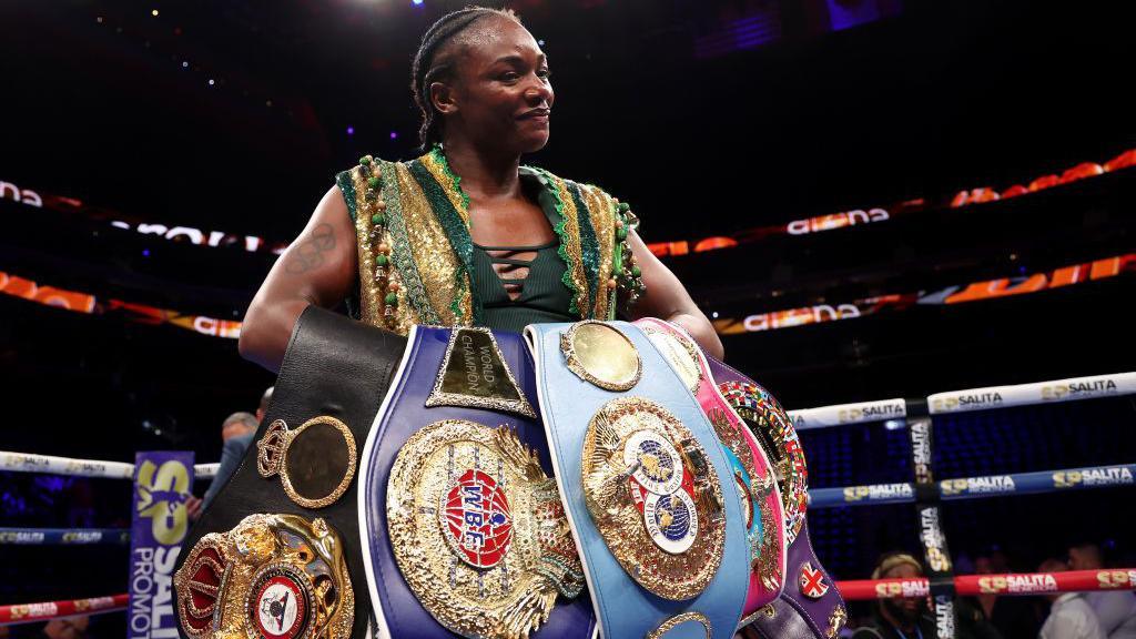 Claressa Shields holds the WBA, WBC, IBF, WBO, WBF and The Ring middleweight titles across her arms