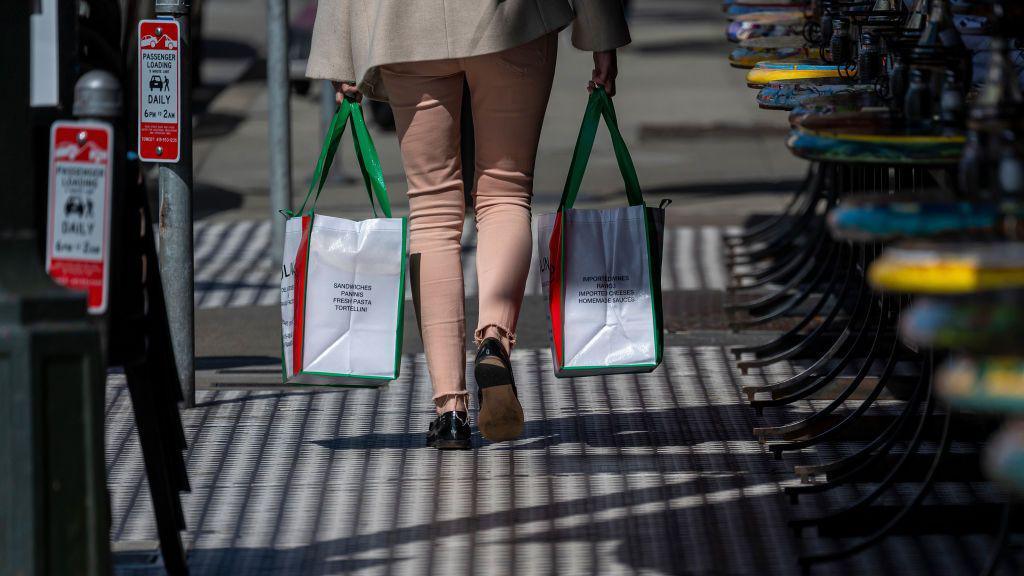 A shopper carries shopping bags in the North Beach neighborhood in San Francisco, California, US, on Tuesday, March 11, 2025. 
