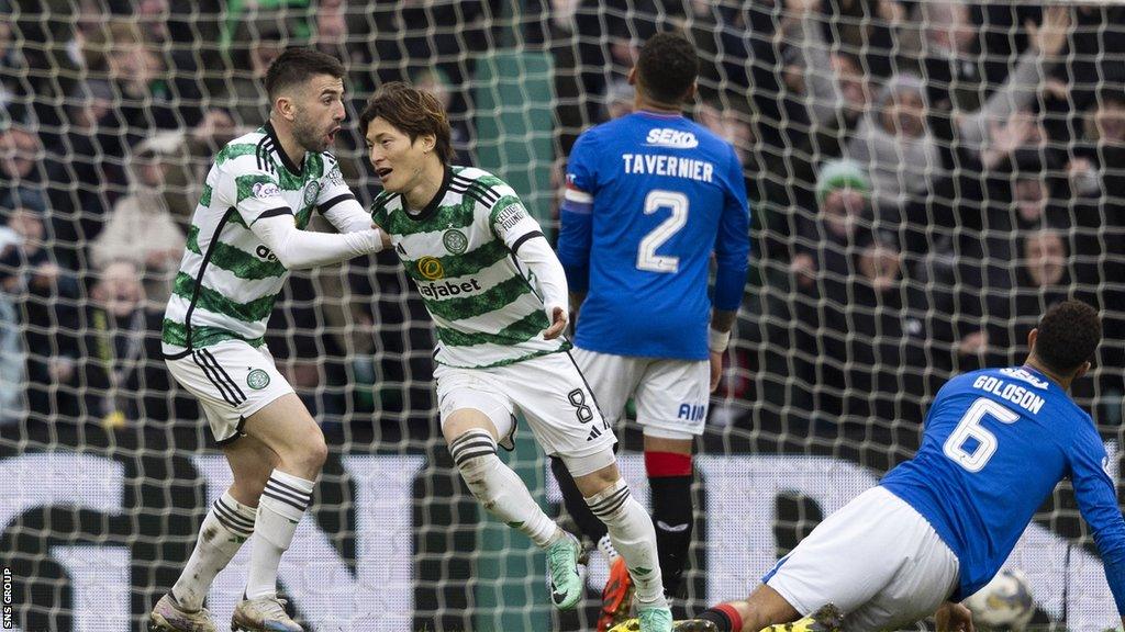 Greg Taylor and Kyogo Furuhashi celebrate against Rangers at Celtic Park on 30 December