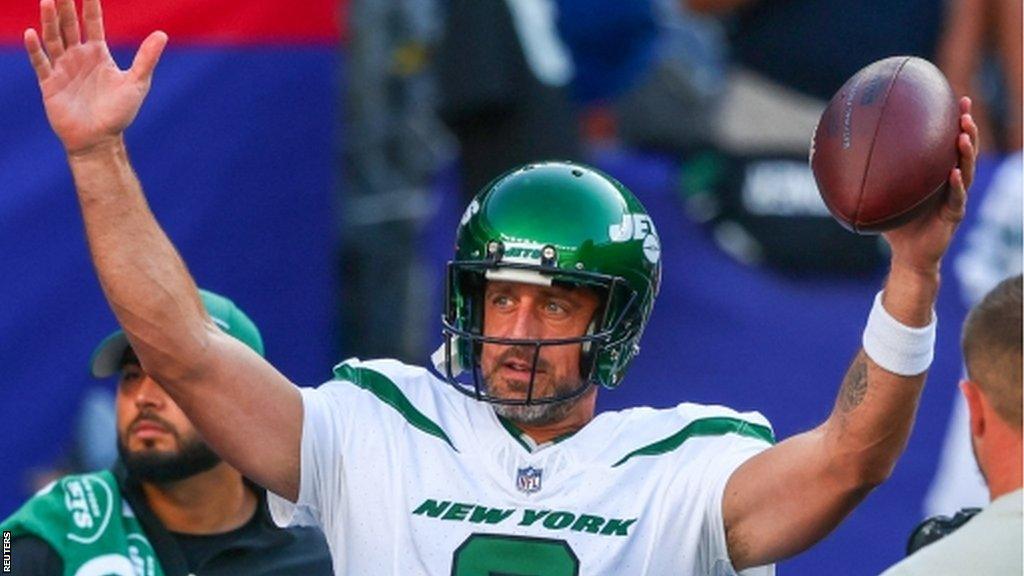 Aaron Rodgers salutes the crowd before a pre-season game for the New York Jets