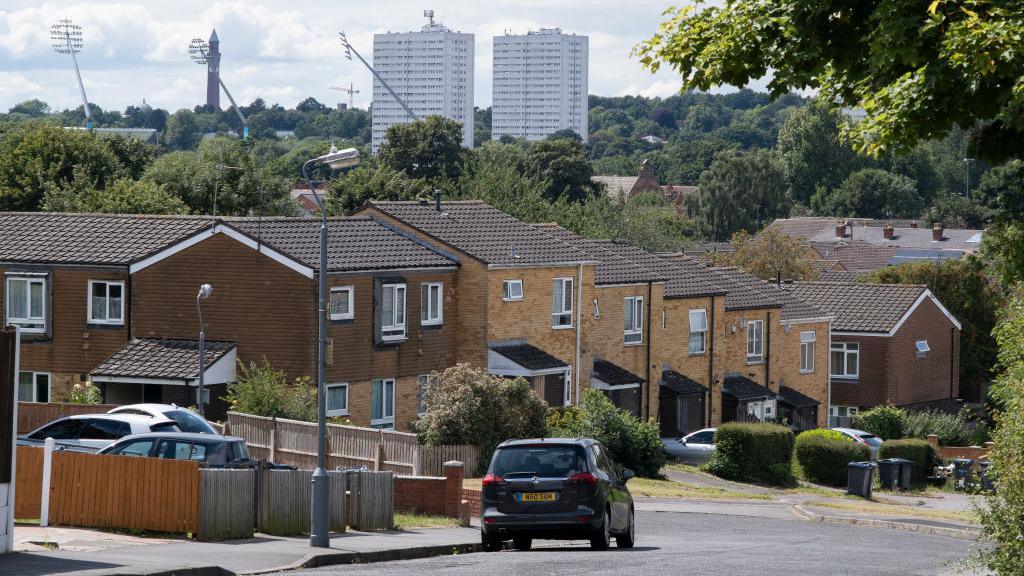 View looking down across terraced housing from Balsall Heath towards tower blocks of high rise flats in Edgbaston, Birmingham