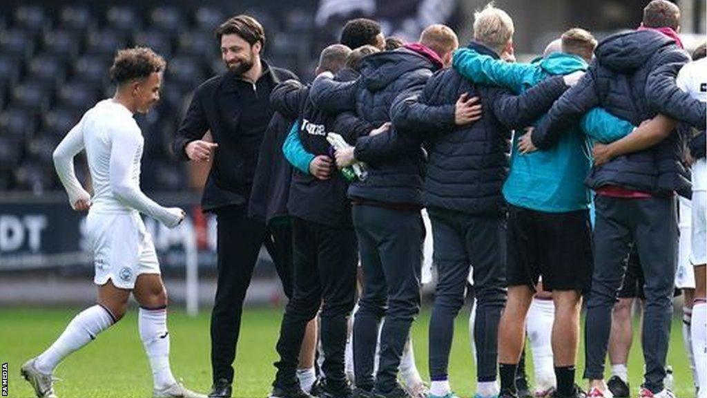 Russell Martin calls players and staff together on the pitch after Swansea's 2-0 win over Bristol City