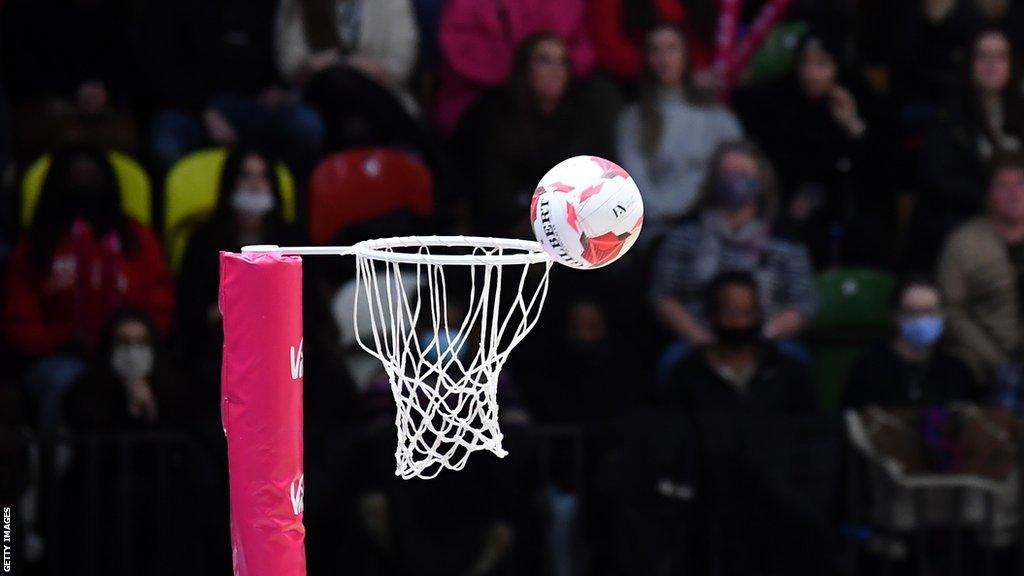 A detailed view of a ball hitting the hoop