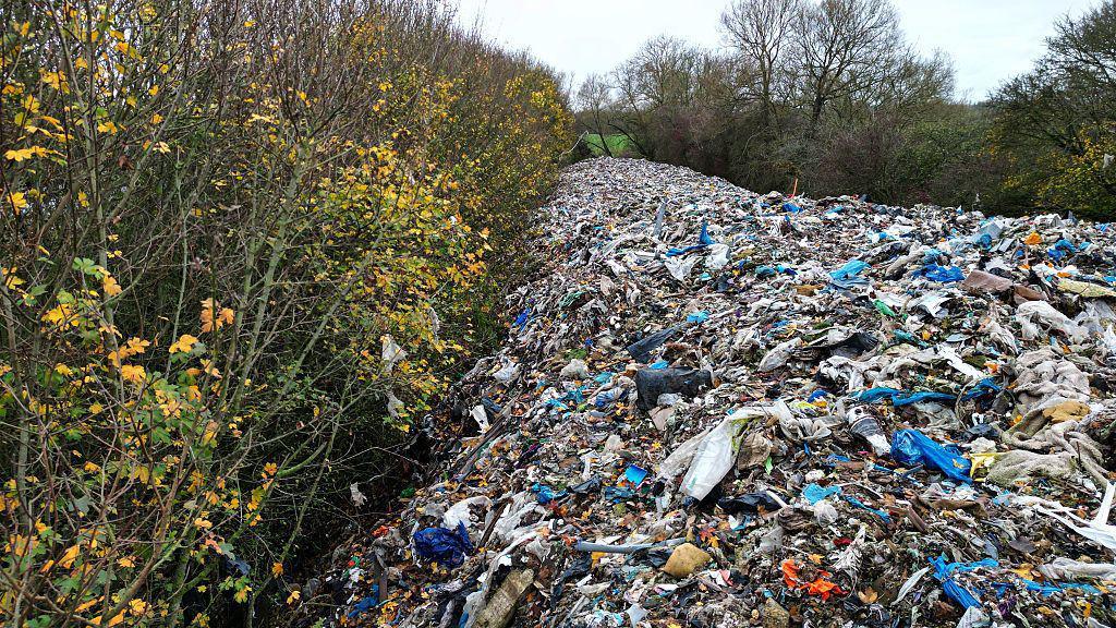 A view of a massive mound of illegally dumped rubbish has turned a field near Kidlington, Oxfordshire, into what locals call an "environmental disaster unfolding before everyone's eyes,"