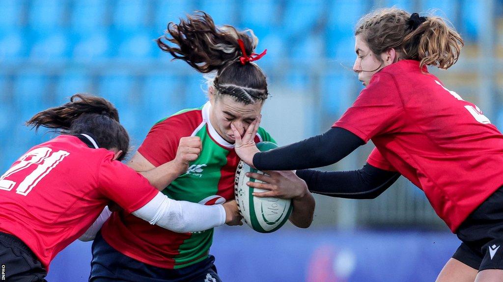 Brython Thunder pair Meg Davies and Katie Mackay tackle Clovers centre Kayla Waldron