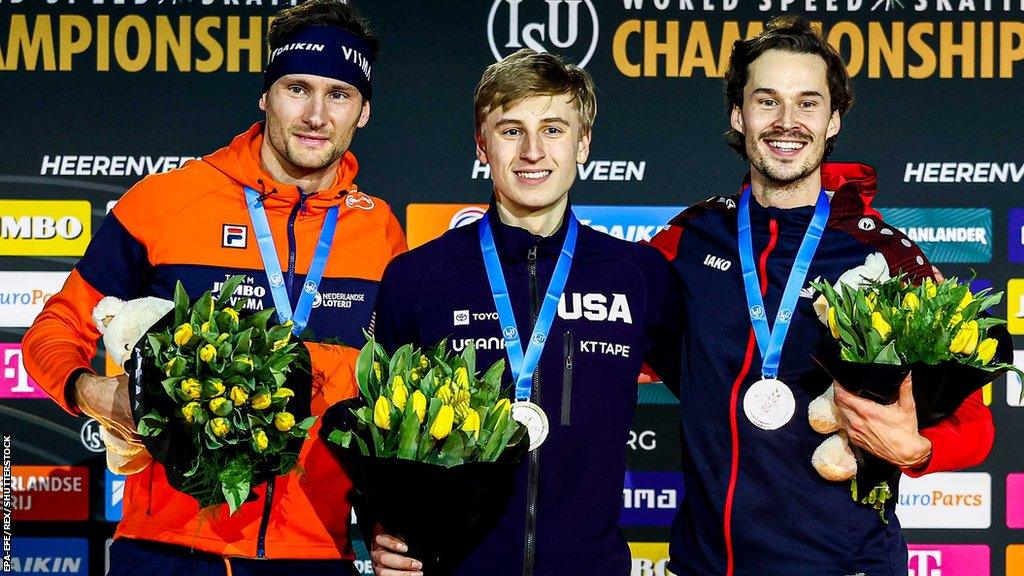 Thomas Krol, Jordan Stolz and Cornelius Kersten pose on the podium after winning the 1000m medals at the 2023 World Speed Skating Championships