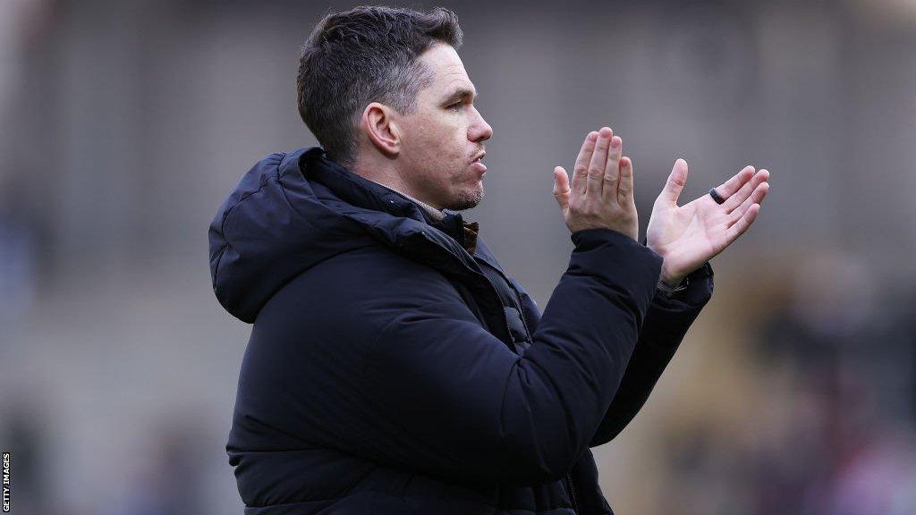Manchester United manager Marc Skinner claps his hands to encourage his players