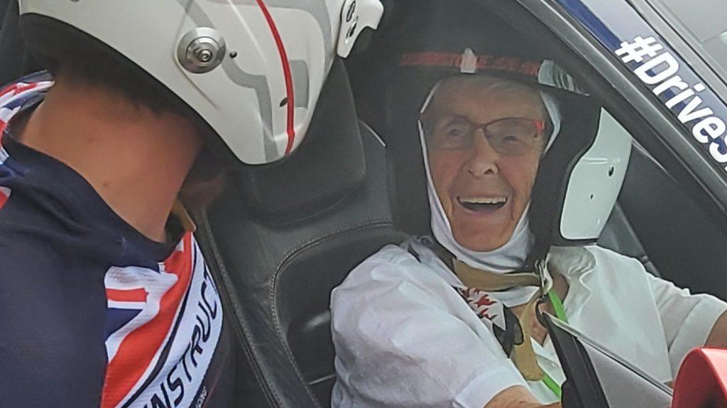 Manette Baillie behind the wheel of a Ferrari at Silverstone.