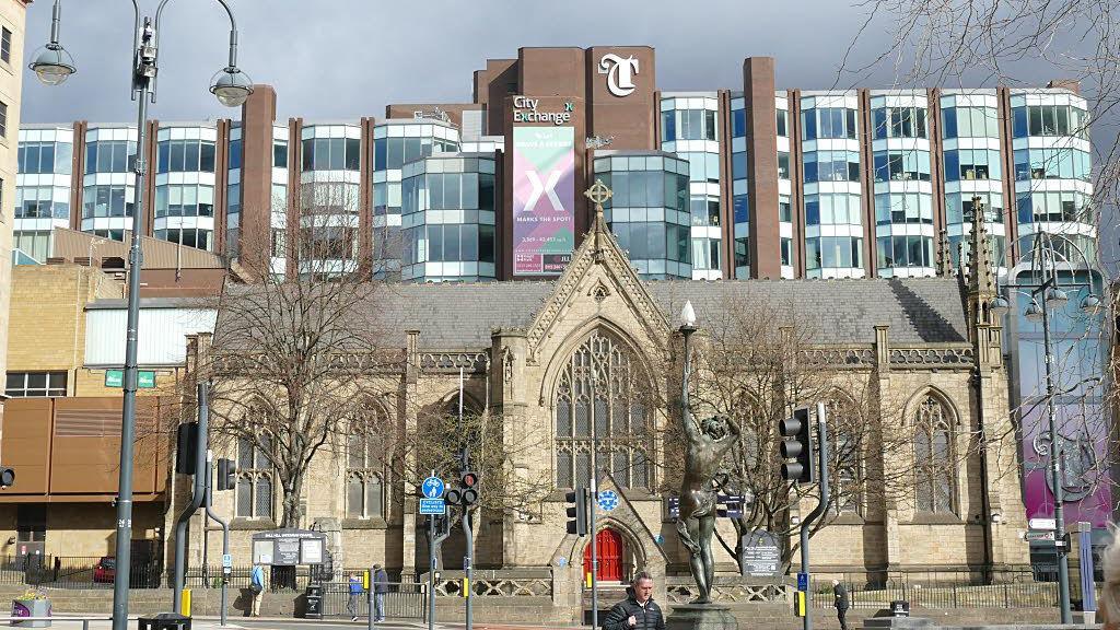 Mill Hill Chapel with Trinity Leeds shopping centre behind it