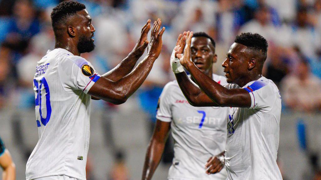 Haiti players celebrate a goal