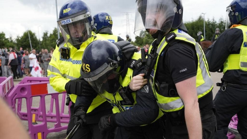 three riot police