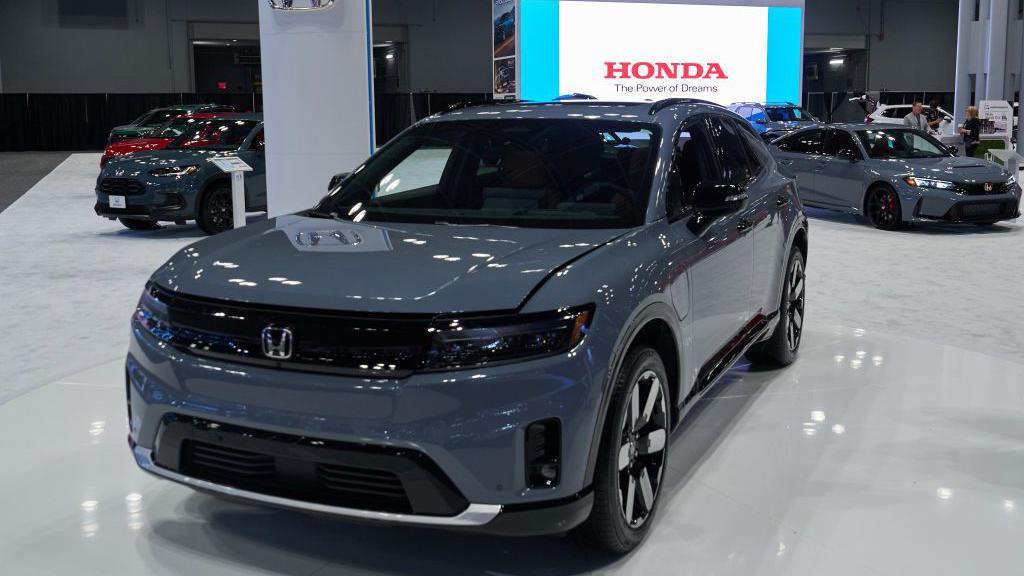 A shiny grey Honda Prologue electric vehicle is displayed at the 2024 New York International Auto show