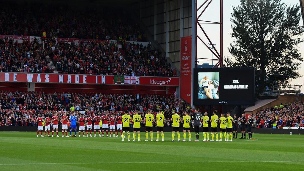 Minute's applause in memory of Nottinghamshire Police Officer, SGT. Graham Saville during the Carabao Cup 2nd Round match between Nottingham Forest and Burnley at the City Ground, Nottingham on Tuesday 29 August 2023