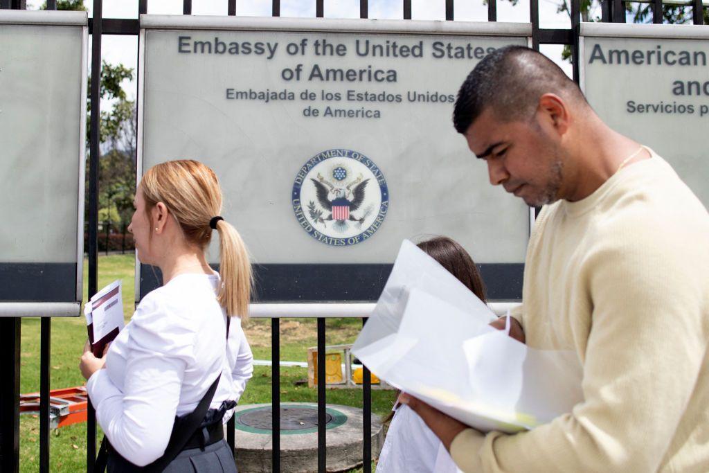 US visa applicants queue outside the US embassy in Bogota, Colombia.