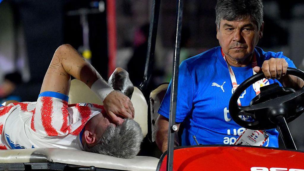 Julio Enciso leaves the pitch on a stretcher after being injured against Nicaragua at the weekend
