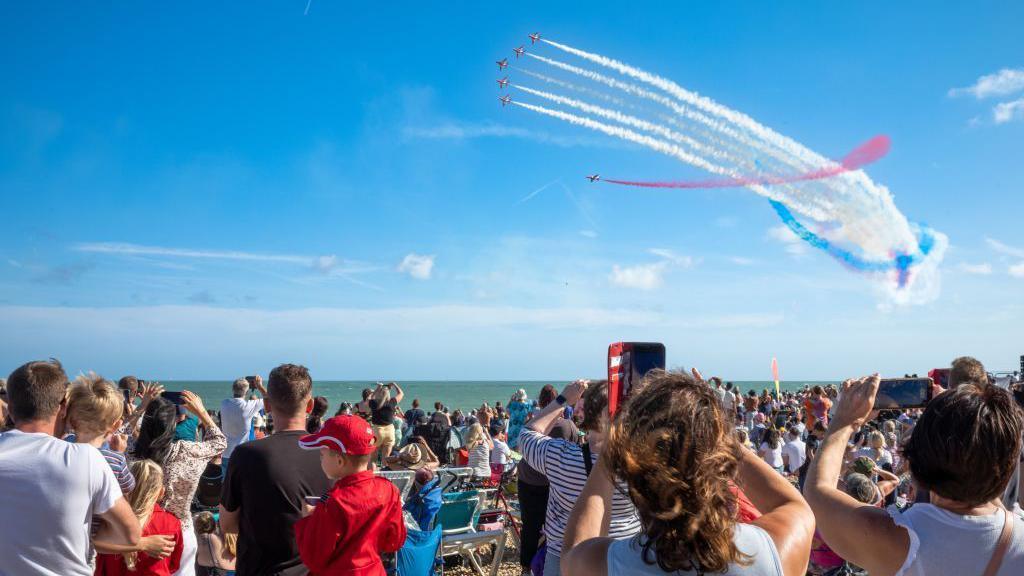 People watch the Red Arrows perform at Eastbourne Airshow