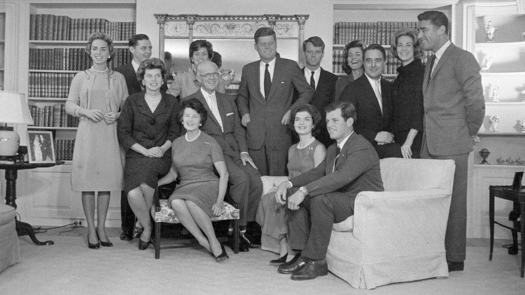 President-elect John F. Kennedy stands at the center of his large family in the living room of his father's home in Hyannisport. Standing by him are: his wife Jacqueline Kennedy; his parents, Joe and Rose Kennedy; brother Robert Kennedy and wife Ethel Ken