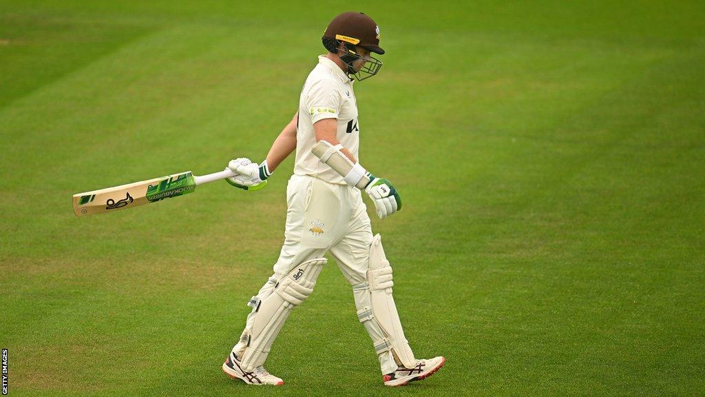 Tom Latham returns to the dressing room after being out for 99