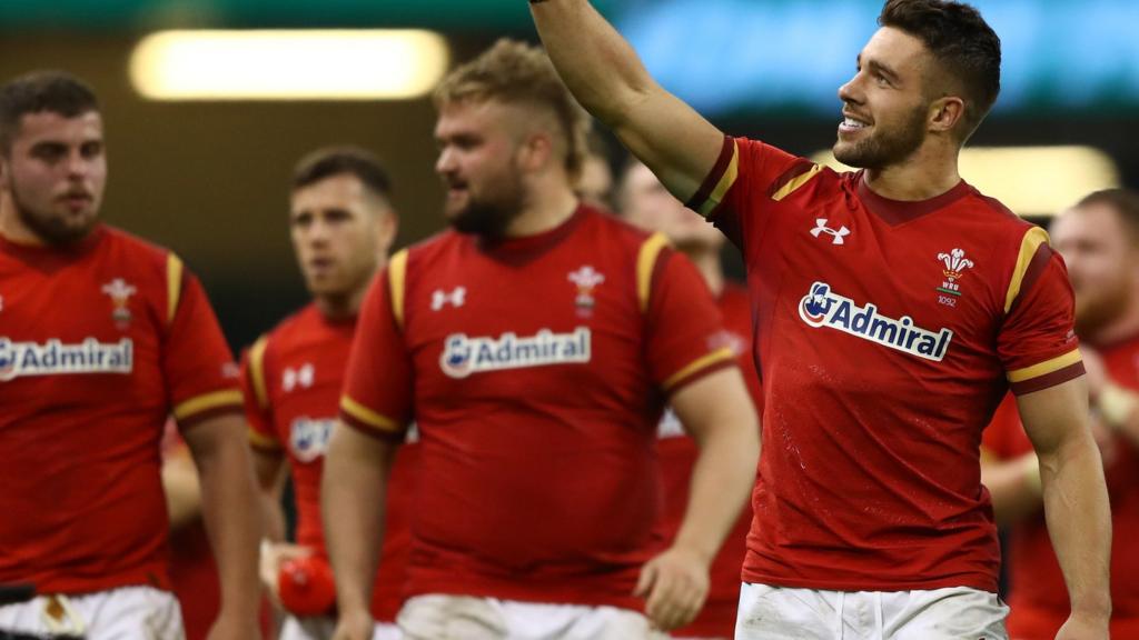 Rhys Webb waves to someone in the crowd