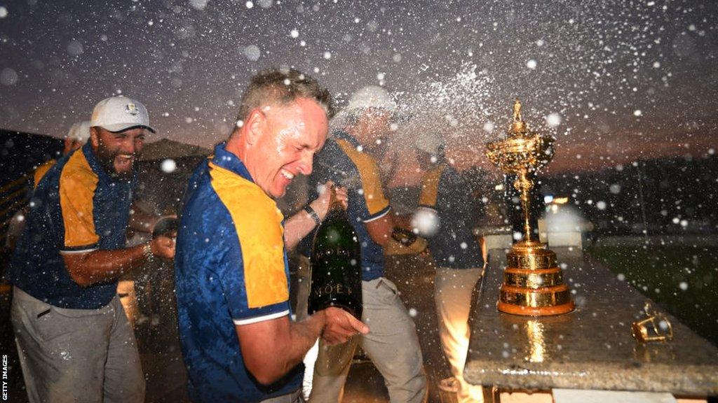 Jon Rahm spraying champagne over Europe captain Luke Donald after winning the Ryder Cup in Rome