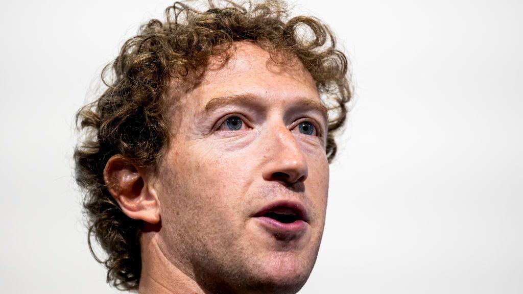 Close-up of Mark Zuckerberg with white background behind him at a promotional event