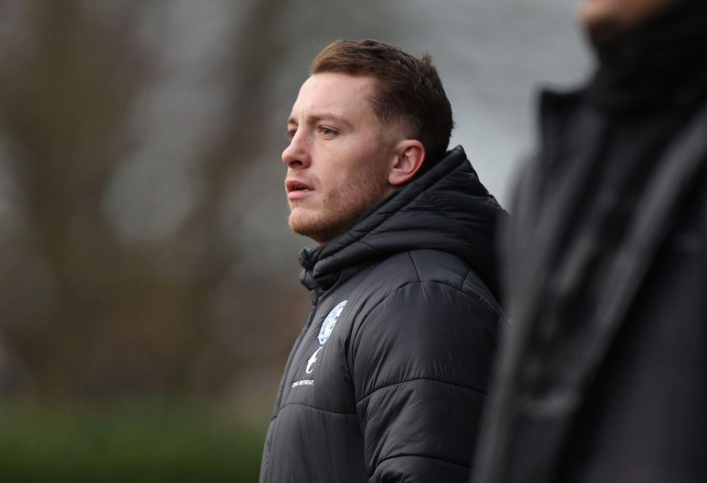 Dan Lawlor watches a match from the touchline