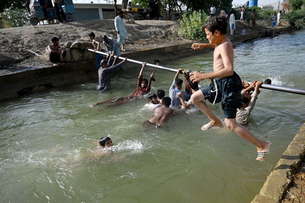 boy jumping into water