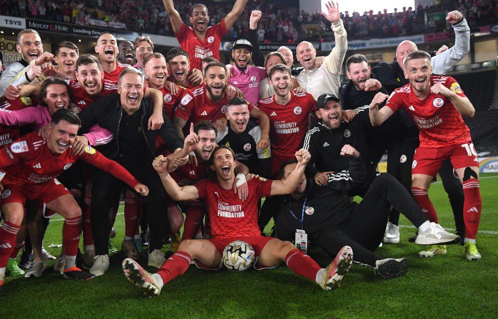 Crawley Town players and staff celebrate