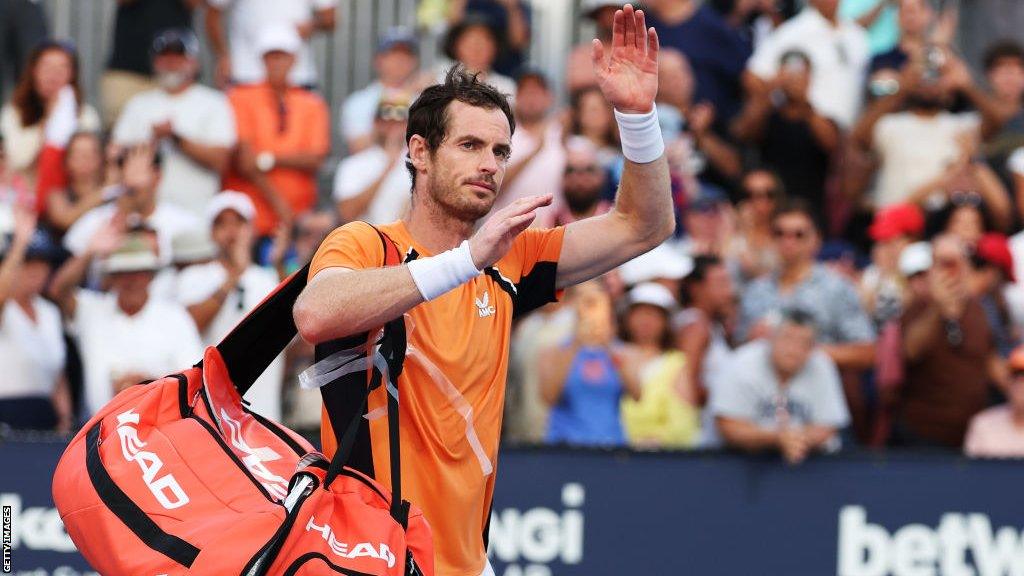 Andy Murray waves as he leaves court