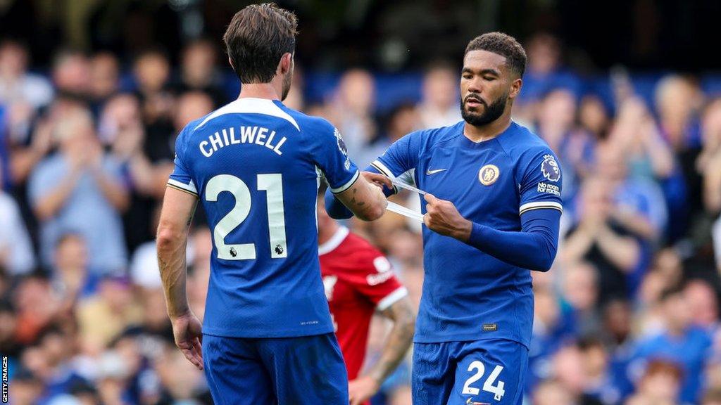 Reece James gives the captain's armband to Ben Chilwell after being substituted during Chelsea's 1-1 draw with Liverpool on Sunday.