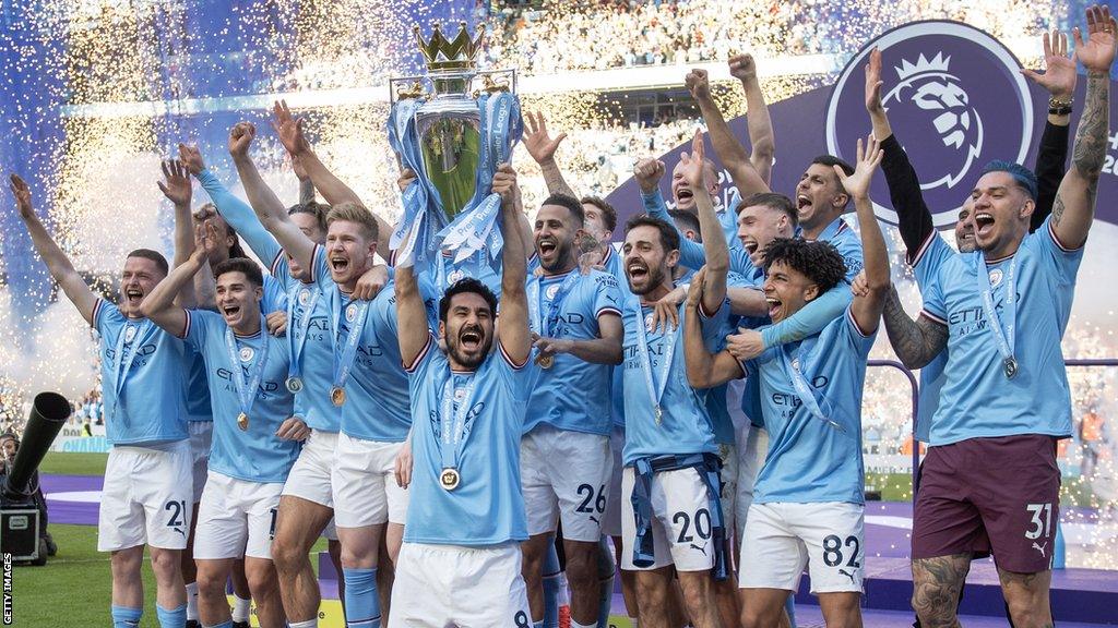 Manchester City players celebrate lifting the Premier League trophy in 2023