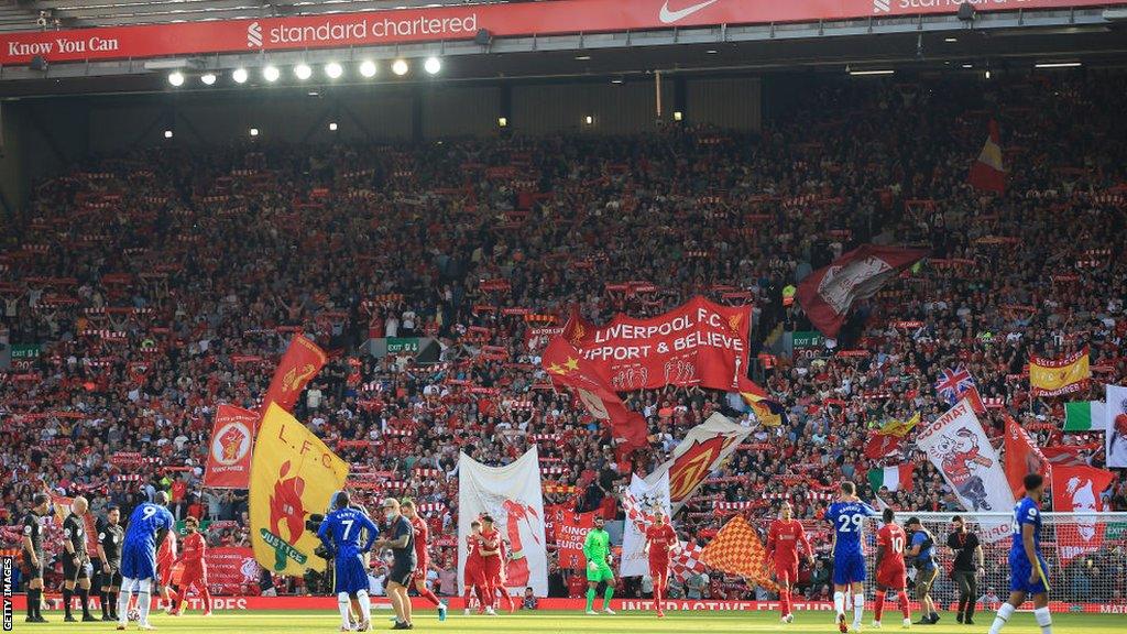 Liverpool and Chelsea player stand on front of the Kop