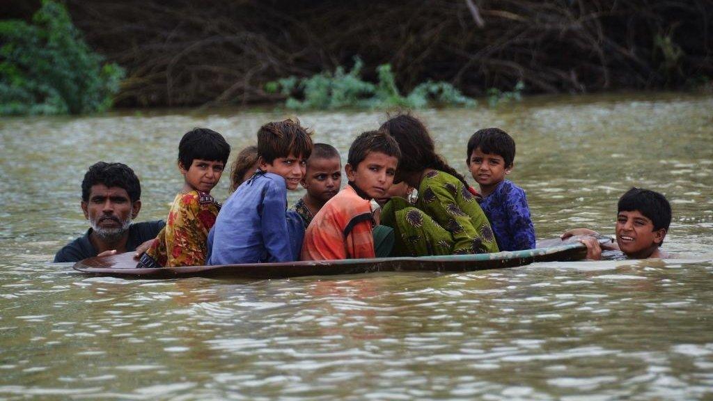 people being rescued from floods in a canpe