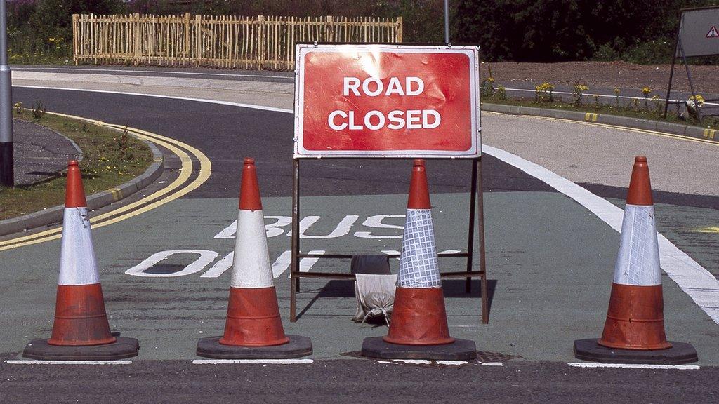 Road closed and traffic cones across the road