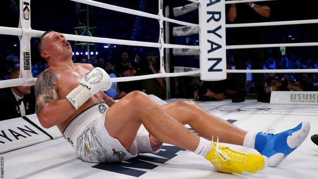 Oleksandr Usyk on the floor after being hit with a low blow by Daniel Dubois