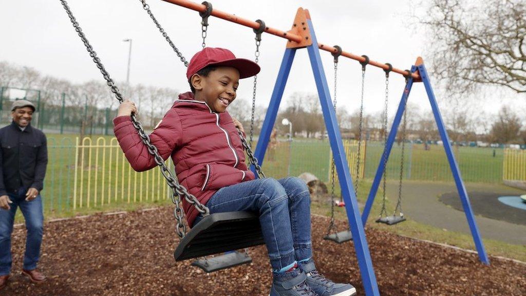 boy-on-swing-in-park.