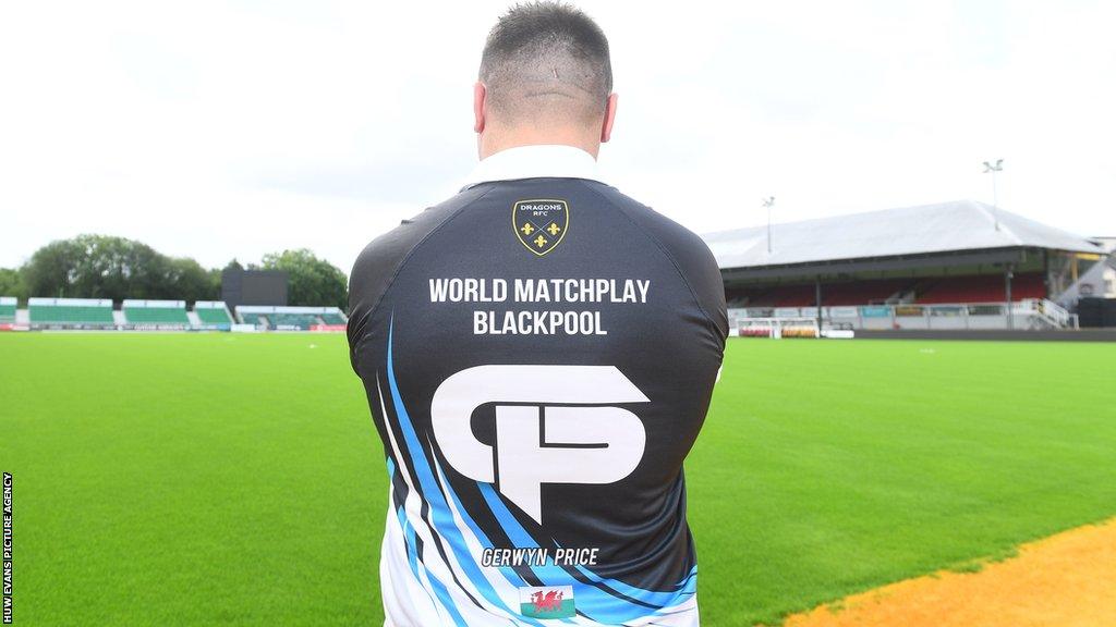 Gerwyn Price shows off the Dragons logo on his darts shirt at Rodney Parade