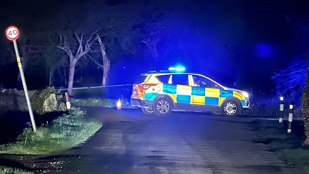 Police cordon and a police car at the scene